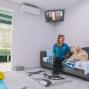 Queen Villa dog suite at AAA Pet Resort with happy dog and staff member